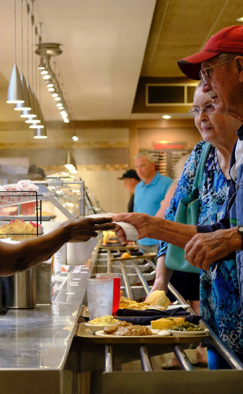 Guests receiving their meal ticket at the end of the K&W serving line