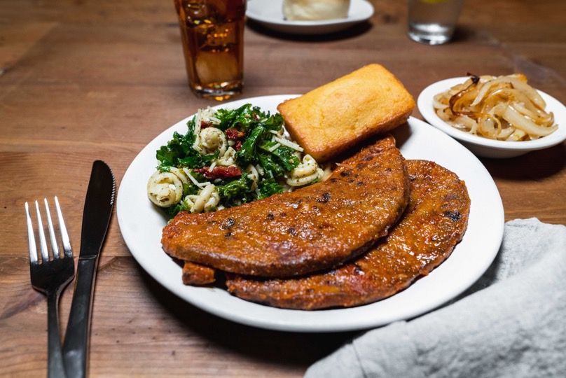 beef liver with pasta salad, cornbread, and grilled onions