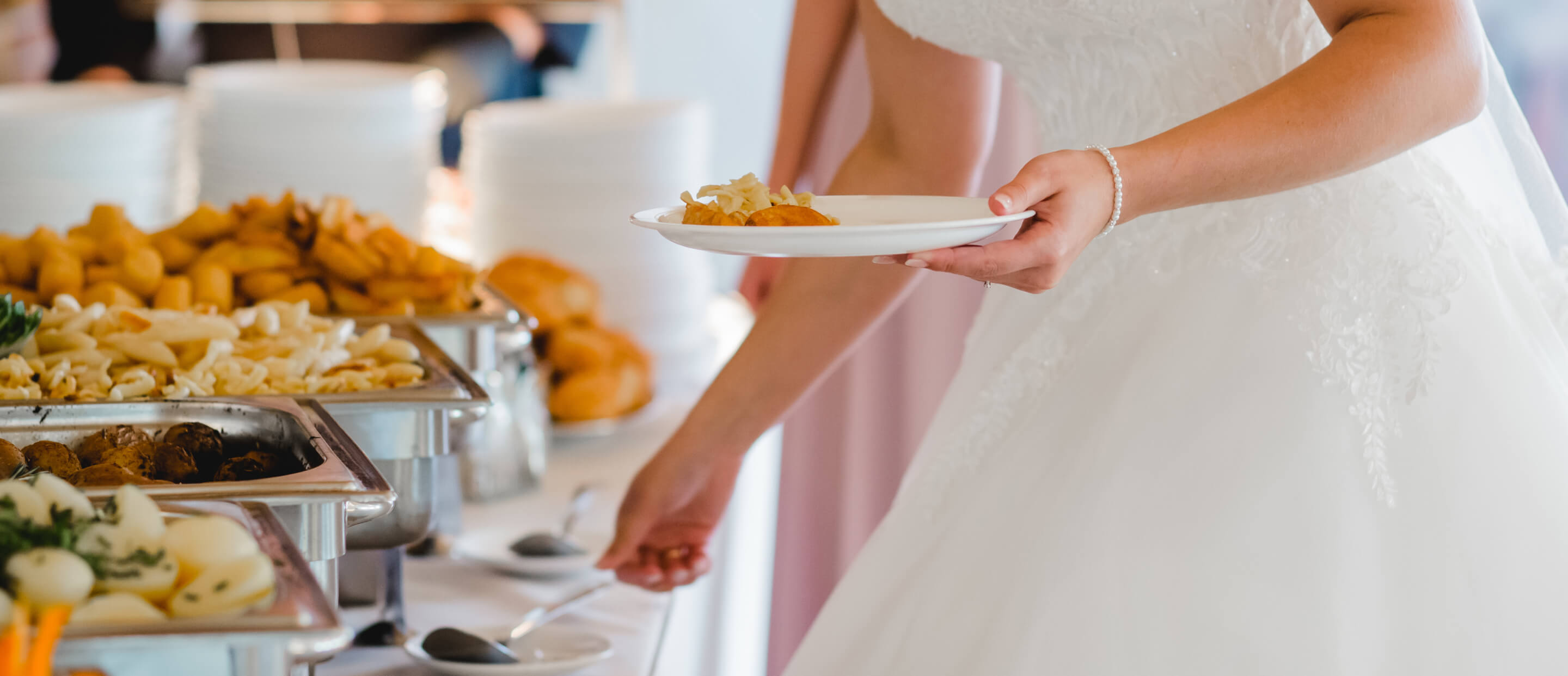 Bride making plate with catered food