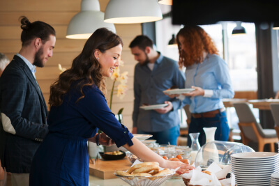 Business people getting lunch from catering table