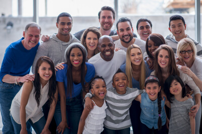 Community of people smiling for a group photo