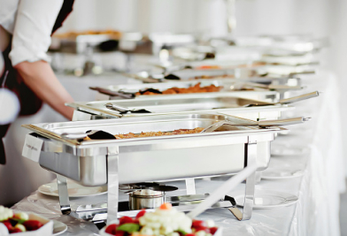 Catering pans of food lined up on table