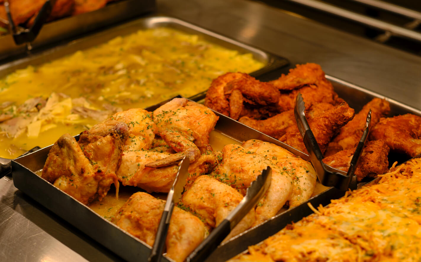 baked chicken, fried chicken, spaghetti and soup on food line