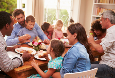 Family gathered around table for dinner