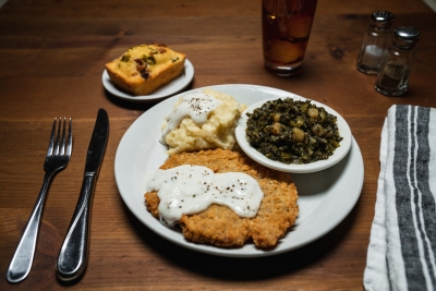 chicken fried steak with gravy, mashed potatoes and turnips