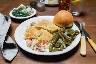chicken pan pie with green beans and a roll