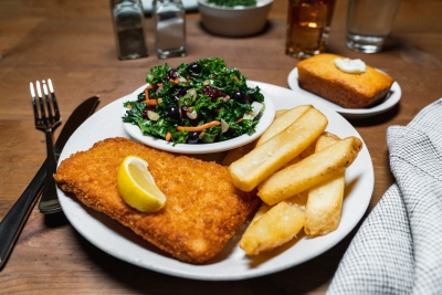 cod square with fries and a kale salad