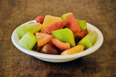 mixed fruit salad with cantaloupe, grapes, strawberries, and kiwi